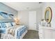 Bedroom with a metal bed frame, dresser, and coastal-themed decor at 2701 Kinsale Ln, Ormond Beach, FL 32174