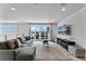 Spacious living room with access to balcony and large TV at 7770 Sandy Ridge Dr # 208, Reunion, FL 34747