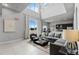 Modern living room with high ceilings, grey sectional sofa and kitchen at 7770 Sandy Ridge Dr # 208, Reunion, FL 34747