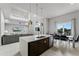 Open concept kitchen with island, stainless steel appliances, and view of living area at 7770 Sandy Ridge Dr # 208, Reunion, FL 34747