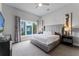 Main bedroom with a king-size bed, large window and TV at 7770 Sandy Ridge Dr # 208, Reunion, FL 34747