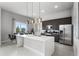 Contemporary kitchen featuring stainless steel appliances and an island at 7770 Sandy Ridge Dr # 208, Reunion, FL 34747