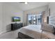 Spacious bedroom with king-size bed and large window with a view at 7770 Sandy Ridge Dr # 208, Reunion, FL 34747