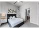 Bright bedroom with queen-size bed and access to hallway at 7770 Sandy Ridge Dr # 208, Reunion, FL 34747
