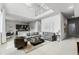 Open concept living room with high ceilings, sectional sofa and kitchen at 7770 Sandy Ridge Dr # 208, Reunion, FL 34747