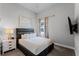 Comfortable bedroom with queen bed and lake view at 7770 Sandy Ridge Dr # 208, Reunion, FL 34747