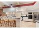 Kitchen with white cabinets, stainless steel appliances, and a breakfast bar at 5006 Cub Lake Dr, Apopka, FL 32703