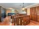 Spacious loft area with hardwood floors and built-in shelving at 5006 Cub Lake Dr, Apopka, FL 32703