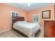 Cozy bedroom with double bed, wood furniture, and window shutters at 5006 Cub Lake Dr, Apopka, FL 32703