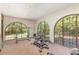 Well-equipped home gym with natural light and backyard views at 5006 Cub Lake Dr, Apopka, FL 32703