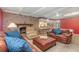 Living room featuring a brick fireplace and comfortable leather furniture at 5006 Cub Lake Dr, Apopka, FL 32703