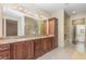 Elegant bathroom with double vanity, granite countertop, and large bathtub at 5006 Cub Lake Dr, Apopka, FL 32703