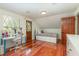 Charming bedroom with wood floors, built-in storage, and access to the outdoors at 5006 Cub Lake Dr, Apopka, FL 32703