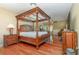 Large main bedroom with a four-poster bed and hardwood floors at 5006 Cub Lake Dr, Apopka, FL 32703