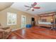 Relaxing main bedroom with hardwood floors, a ceiling fan, and sitting area at 5006 Cub Lake Dr, Apopka, FL 32703
