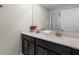 Bathroom with double vanity, granite countertop, and dark brown cabinets at 1224 Challenge Dr, Davenport, FL 33896