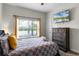 Bright bedroom with a queen bed and window with natural light at 1224 Challenge Dr, Davenport, FL 33896