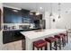 Modern kitchen with stainless steel appliances and an island with seating at 1224 Challenge Dr, Davenport, FL 33896