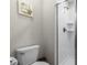 Small bathroom with toilet, shower, and a framed print on the wall at 1224 Challenge Dr, Davenport, FL 33896