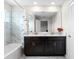 Bathroom with double vanity, marble tile, and a bathtub at 1224 Challenge Dr, Davenport, FL 33896