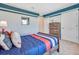 bedroom with wood bed frame, blue and white bedding, and sports decor at 2738 House Finch Rd, Saint Cloud, FL 34773