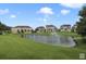Landscaped pond with fountain and homes in background at 801 Lobelia Dr, Lake Mary, FL 32746