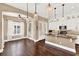 Bright kitchen with granite island, white cabinets, and hardwood floors at 801 Lobelia Dr, Lake Mary, FL 32746