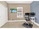 Home office with corner desk, two monitors, and TV at 801 Lobelia Dr, Lake Mary, FL 32746