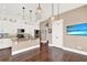 Open kitchen with granite island, white cabinets, and hardwood floors at 801 Lobelia Dr, Lake Mary, FL 32746