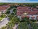 Aerial view showcasing community townhouses, roads, and mature trees at 801 Lobelia Dr, Lake Mary, FL 32746
