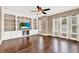 Gathering room with built-in shelving, hardwood floors and a large TV at 801 Lobelia Dr, Lake Mary, FL 32746
