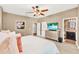 Main bedroom with large bed, ceiling fan, and ensuite bathroom access at 801 Lobelia Dr, Lake Mary, FL 32746