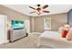 Main bedroom with large bed, ceiling fan, and dresser at 801 Lobelia Dr, Lake Mary, FL 32746
