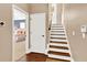 View of a staircase leading to the upper level of the home, with hardwood floors and a neutral color palette at 801 Lobelia Dr, Lake Mary, FL 32746