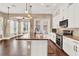 Modern kitchen featuring granite countertops, white cabinetry, and stainless steel appliances at 801 Lobelia Dr, Lake Mary, FL 32746
