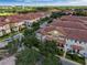 Aerial perspective of townhouses, roads, and surrounding landscape at 801 Lobelia Dr, Lake Mary, FL 32746