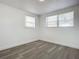 Bright bedroom with wood-look floors and windows at 1122 Lewis Dr, Daytona Beach, FL 32117