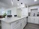 Modern kitchen with white cabinets, quartz countertops and island at 1122 Lewis Dr, Daytona Beach, FL 32117