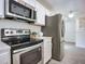 Stainless steel appliances and white cabinetry in this kitchen at 1122 Lewis Dr, Daytona Beach, FL 32117