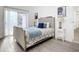 Bright bedroom with wood-look floors and sliding door access at 1122 Lewis Dr, Daytona Beach, FL 32117