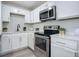 White kitchen with stainless steel appliances and quartz countertops at 1122 Lewis Dr, Daytona Beach, FL 32117