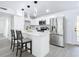 Modern kitchen featuring white cabinets, stainless steel appliances, and a breakfast bar at 1122 Lewis Dr, Daytona Beach, FL 32117
