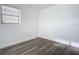 Simple bedroom with wood-look floors and a window at 1122 Lewis Dr, Daytona Beach, FL 32117
