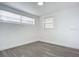 Bedroom with wood-look floors and two windows at 1122 Lewis Dr, Daytona Beach, FL 32117