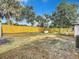 Large backyard with wooden fence and storage shed at 1122 Lewis Dr, Daytona Beach, FL 32117