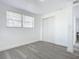 Bedroom with wood-look floors, window and closet at 1122 Lewis Dr, Daytona Beach, FL 32117