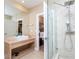Elegant bathroom with a large vanity, glass shower, and bedroom view at 7527 Brooklyn Dr # 7527, Kissimmee, FL 34747