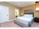 King-size bed, en-suite bathroom and neutral decor at 7527 Brooklyn Dr # 7527, Kissimmee, FL 34747