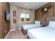 Bedroom with two twin beds, wood-paneled walls, and a TV at 7527 Brooklyn Dr # 7527, Kissimmee, FL 34747