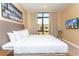 King-size bed, large window, and TV with city view at 7527 Brooklyn Dr # 7527, Kissimmee, FL 34747